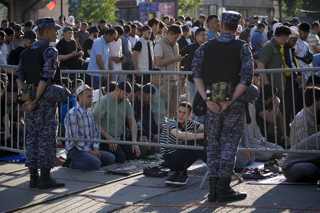 Muslims wait prior to offer Eid al-Adha prayers at the Moscow Cathedral Mosque during celebrations in Moscow, Russia, Sunday, June 16, 2024. Muslims around the world celebrate Eid al-Adha, or the Feast of the Sacrifice, slaughtering sheep, goats, cows and camels to commemorate Prophet Abraham's readiness to sacrifice his son Ismail on God's command. (Photo by Alexander Zemlianichenko/AP Photo)