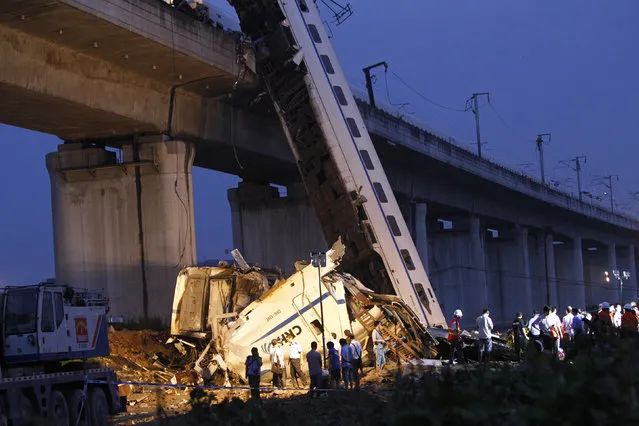 Rescuers carry out rescue operations after two carriages from a bullet train derailed and fell off a bridge in Wenzhou, Zhejiang province, July 24, 2011. (Photo by Aly Song/Reuters)