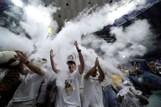 LSU fans in the student section throw talcum powder into the air before the start of an NCAA college basketball game against Alabama in Baton Rouge, La., Saturday, March 5, 2022. (Photo by Gerald Herbert/AP Photo)
