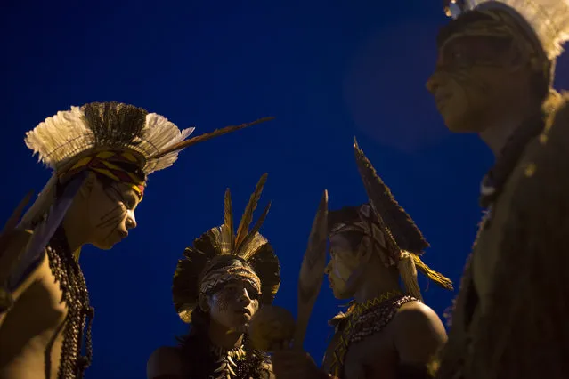 Pataxo Indians gather during the indigenous games in Cuiaba, Brazil, Tuesday, November 12, 2013. Around 1,600 Indians from 48 tribes are celebrating Brazil's indigenous cultures during the 12th edition of the Games of the Indigenous People, which runs until Nov. 16. (Photo by Felipe Dana/AP Photo)