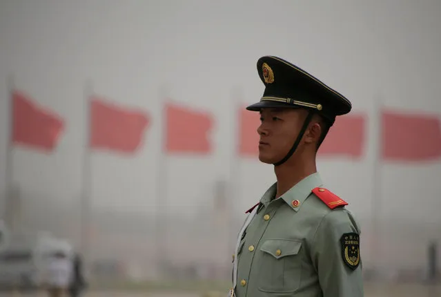 A paramilitary police officer stands guard at Tiananmen Square as a dust storm hits Beijing, China May 4, 2017. (Photo by Jason Lee/Reuters)