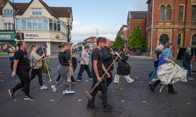 Members of the Middlesbrough community come together to clean up their streets after far-right activists destroyed property following riots on August 05, 2024 in Middlesbrough, England. Dozens of people have been arrested after a violent protest here yesterday, in which a car was set alight, windows were smashed, and objects were thrown at police. (Photo by Ian Forsyth/Getty Images)