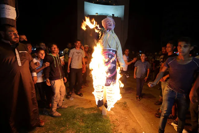 Palestinian demonstrators burn an effigy depicting U.S. President Donald Trump during a protest in Rafah in the southern Gaza Strip May 22, 2017. (Photo by Ibraheem Abu Mustafa/Reuters)