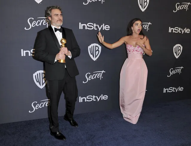 Joaquin Phoenix, winner of the award for best performance by an actor in a motion picture drama for “Joker”, left, and Sarah Hyland arrive at the InStyle and Warner Bros. Golden Globes afterparty at the Beverly Hilton Hotel on Sunday, January 5, 2020, in Beverly Hills, Calif. (Richard Shotwell/Invision/AP Photo)