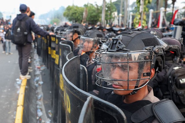 Riot police stand in line, as people protest outside the Indonesian Parliament against the revisions to the country's election law, which analysts believe goes through a rushed process of legislation and is designed to block a popular candidate from running as the capital's governor in Jakarta, Indonesia on August 22, 2024. (Photo by Ajeng Dinar Ulfiana/Reuters)