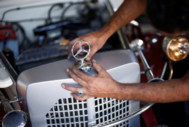 Palestinian Munir Shindi, 36, adjusts a replica of a 1927 Mercedes Gazelle that he built from scratch, in his workshop in Gaza City June 19, 2016. (Photo by Mohammed Salem/Reuters)