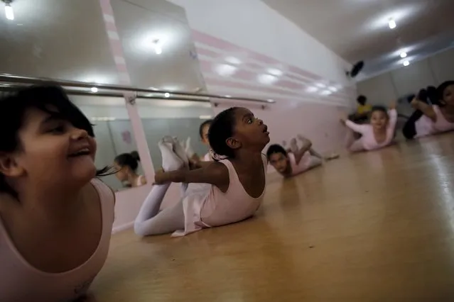 Young girls take ballet lessons at the New Dreams dance studio in the Luz neighborhood known to locals as Cracolandia (Crackland) in Sao Paulo, Brazil, August 14, 2015. (Photo by Nacho Doce/Reuters)