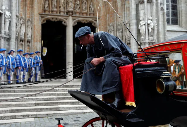 A volunteer dressed as a coachman waits outside the Church of the Sablon during an annual Renaissance pageant, the Ommegang parade, which commemorates the 16th century arrival of Habsburg Emperor Charles V, in central Brussels, Belgium, July 7, 2016. Picture taken July 7, 2016. (Photo by Francois Lenoir/Reuters)