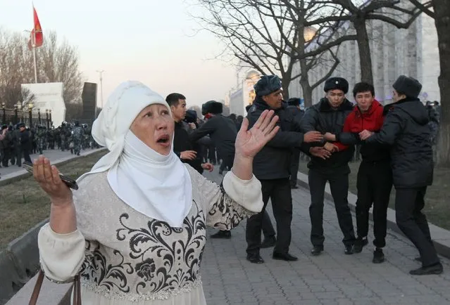 A woman reacts as Kazakh law enforcement officers detain a man during a rally of jailed politician Sadyr Zhaparov's supporters in central Bishkek, Kyrgyzstan on March 2, 2020. (Photo by Vladimir Pirogov/Reuters)