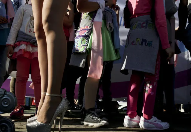 In this July 1, 2017 photo, transgender girls stand by a transvestite during a Gay Pride march in Santiago, Chile. The center-left government has been pushing an array of measures for gender rights, ranging from decriminalizing some abortions to demanding greater acceptance for transgender people in general and children in particular. (Photo by Esteban Felix/AP Photo)