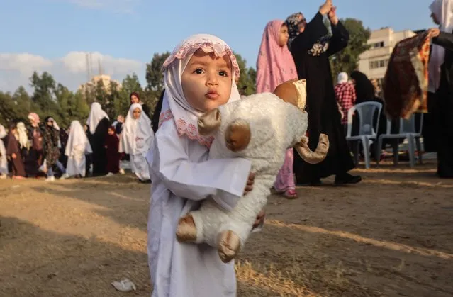 A Palestinian child, dressed in new clothes, walks in the street in Gaza City, during the Eid al-Adha holiday, on July 9, 2022. (Photo by Mohammed Abed/AFP Photo)