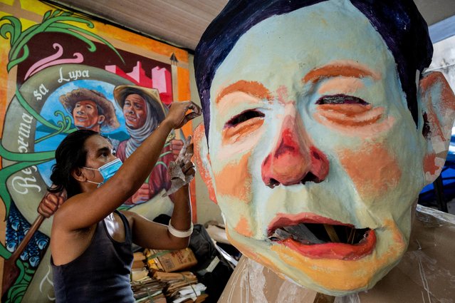 A Filipino activist builds an effigy depicting Philippine President Ferdinand Marcos Jr. ahead of Marcos' first State of the Nation Address, in Quezon City, Metro Manila, Philippines on July 24, 2022. (Photo by Lisa Marie David/Reuters)
