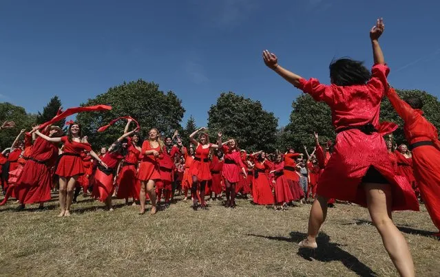 Both men and women dressed as singer Kate Bush from her 1978 video to her song “Wuthering Heights” dance while seeking to create a new world's record for the most people dancing in costume to the song at once at Tempelhofer Feld park on July 16, 2016 in Berlin, Germany. While a precise account was unavailable just after the event, a calculated estimate put the number of dancers at between 400 and 500, well above the previous record set in 2013 in Brighton, UK of 300. (Photo by Sean Gallup/Getty Images)