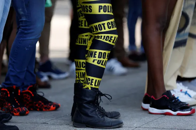 A protestor in police tape-themed clothing is seen during a protest against recent police-related shootings in Louisiana and Minnesota, in Oakland, California, U.S. July 15, 2016. (Photo by Stephen Lam/Reuters)