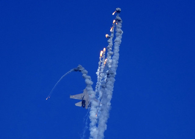An Indian Air Force fighter aircraft Sukhoi Su-30 fires flares during Air Force Day celebrationS at Sangam, the holy confluence of river Ganga, Yamuna and the mythical Saraswati, in Prayagraj, India Sunday, October 8, 202303. Air Force Day is celebrated to mark the day the Indian air force, the fourth largest air force in the world, was officially established in 1932. (Photo by Rajesh Kumar Singh/AP Photo)