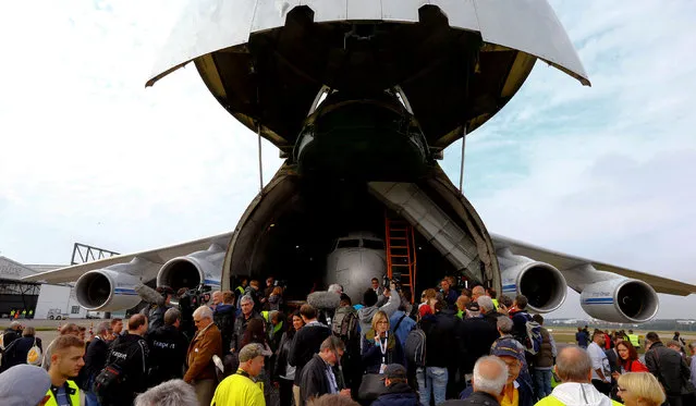 People stand in front of a Russian Volga-Dnepr Airlines Antonov An-124 aircraft transporting the fuselage of a Boeing 737-200, also known as Landshut, after its arrival at the airport in Friedrichshafen, Germany September 23, 2017. (Photo by Arnd Wiegmann/Reuters)