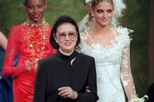 Japanese fashion designer Hanae Mori, center, is applauded by models after the presentation of her 1997-98 fall-winter haute couture collection presented in Paris, July 9, 1997. Mori, known for her elegant signature butterfly motifs, has died, according to local media reports. She was 96. (Photo by Michel Lipchitz/AP Photo/File)