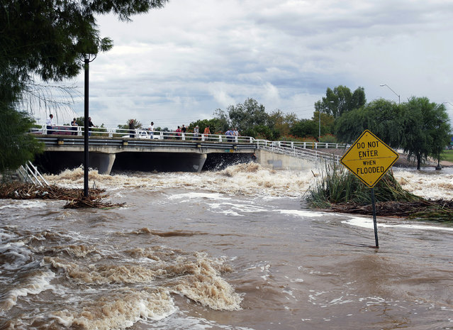 Floodwaters surge Monday, September 8, 2014, in Scottsdale, Ariz. The remnants of Hurricane Norbert pushed into the desert Southwest and swamped Arizona Monday, breaking the previous record for rainfall in a single day in Phoenix. (Photo by Rick Scuteri/AP Photo)