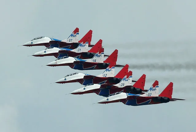 Mikoyan MiG-29 jet fighters of the Strizhi (Swifts) aerobatic team fly in formation during the International Army Games 2016, in Dubrovichi outside Ryazan, Russia, August 5, 2016. (Photo by Maxim Shemetov/Reuters)