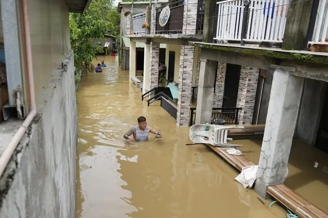 A resident wades through chest-deep floodwater from to Typhoon Noru in San Miguel town, Bulacan province, Philippines, Monday, September 26, 2022. (Photo by Aaron Favila/AP Photo)