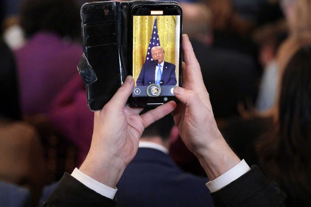 A reporter makes a video of U.S. President Donald Trump as he speaks during a news conference with Israeli Prime Minister Benjamin Netanyahu in the East Room of the White House on February 04, 2025 in Washington, DC. Netanyahu is the first foreign leader to visit Trump since he returned to the White House last month. (Photo by Chip Somodevilla/Getty Images)