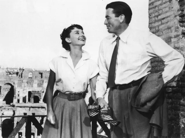 Belgian-born actor Audrey Hepburn (1929–1993) holds the hand of American actor Gregory Peck in a still from the film “Roman Holiday”, directed by William Wyler, 1953. Actor Gregory Peck died June 12, 2003 at age 87 of natural causes in his Los Angeles, California home. (Photo by Paramount Pictures)