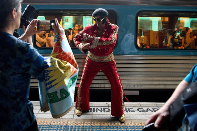 Alfred Vaz (C) poses for photographs dressed as Elvis Presley ahead of the departure of the Elvis Express bound for Parkes, at Central Station in Sydney, Australia, 11 January 2024. More than 25,000 Elvis enthusiasts are expected to make the annual pilgrimage to Parkes NSW, making it the largest congregation of Elvis fans in the Southern Hemisphere. (Photo by Bianca De Marchi/EPA)