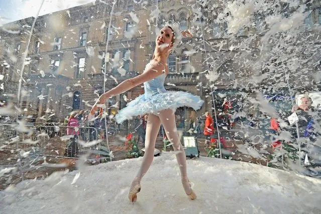 Claire Robertson from Scottish Ballet, poses dressed as the Good Snow Flake inside a life size snow globe on Buchanan Street during a promotion for Scottish Ballet's festive production of The Nutcracker on November 20, 2012 in Glasgow, Scotland. The Nutcracker opens at the Theatre Royal on December the 8th, the production delves deep into the darker reaches of Hoffmann's original tale in a fresh and vivid retelling of the famous Christmas story. (Photo by Jeff J. Mitchell)