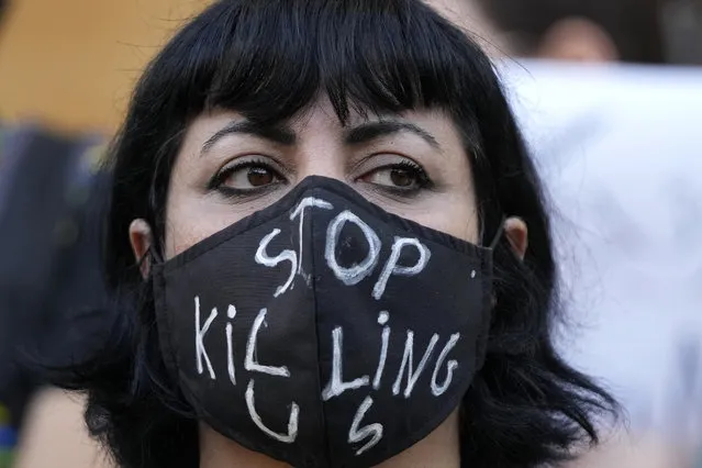 An activist wears a message on her protective face mask “Stop Killing Us” during a protest against the death of Iranian Mahsa Amini in Iran, in Beirut, Lebanon, Sunday, October 2, 2022. Iran's parliamentary speaker Mohammad Bagher Qalibaf warned Sunday that protests over the death of the young woman in police custody could destabilize the country and urged security forces to deal harshly with those he claimed endanger public order, as countrywide unrest entered its third week. (Photo by Hassan Ammar/AP Photo)