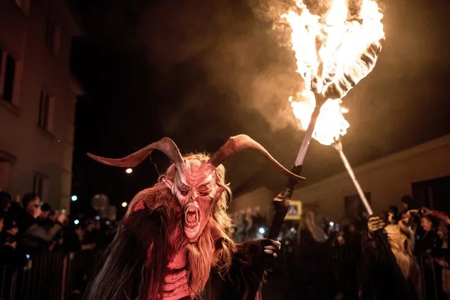 Participants dressed as Krampus walk at the street during Krampus gathering on November 26, 2016 in Zidlochovice (at Brno), Czech Republic. (Photo by Lukas Kabon/Anadolu Agency/Getty Images)