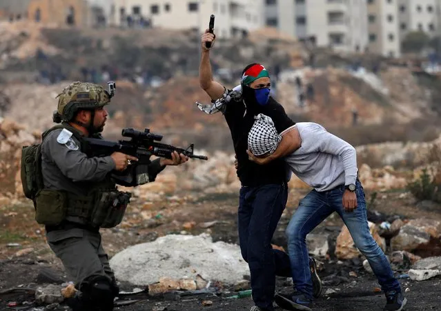 Undercover Israeli security personnel detain a Palestinian demonstrator during clashes at a protest against U.S. President Donald Trump's decision to recognize Jerusalem as the capital of Israel, near the Jewish settlement of Beit El, near the West Bank city of Ramallah December 13, 2017. (Photo by Mohamad Torokman/Reuters)