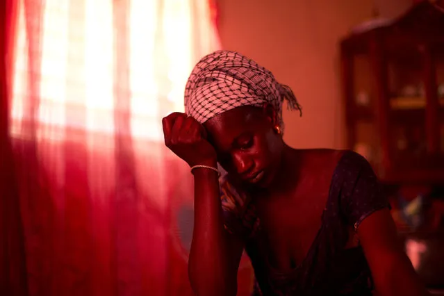 In this October 10, 2013 photo, Aida Diallo, whose ten-year-old son Bamba was killed when a fire struck the Dakar shack where he was sleeping along with other Quranic students, sits in her one-room home in the village of Ndame, Senegal. Bamba's older brother Cheikhou, 13, managed to escape the fire which killed Bamba and three of their cousins. (Photo by Rebecca Blackwell/AP Photo)