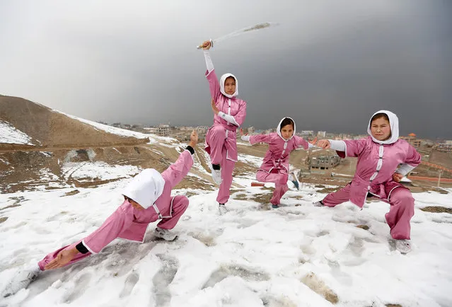 Hanifa Doosti (C), 17, and other students of the Shaolin Wushu club show their Wushu skills to other students on a hilltop in Kabul, Afghanistan January 29, 2017. (Photo by Mohammad Ismail/Reuters)