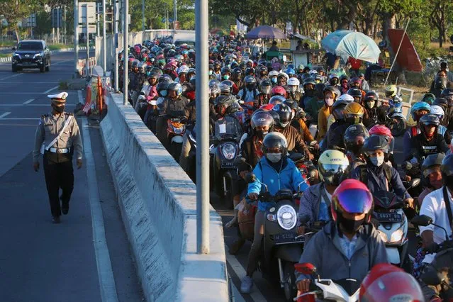 Thousands of Madurese who live in Surabaya and several areas in East Java province, queue at the Suramadu toll bridge gate on the Surabaya side to cross to Madura Island because it will carry out to going home or called the Toron tradition in SUrabaya, East Java province, Indonesia on July 30. 2020. Madurese people have a Toron tradition, which is to return to their hometown during the Eid al-Adha celebration. (Photo by  Budiono/Sijori images/Barcroft Media via Getty Images)
