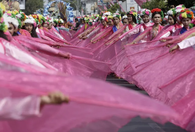 Dancers perform during a traditional festival of "ngarot" in Indramayu, West Java, Indonesia, Wednesday, October 7, 2015. The festival is held regularly every year to welcome the rice planting season. (Photo by Tatan Syuflana/AP Photo)