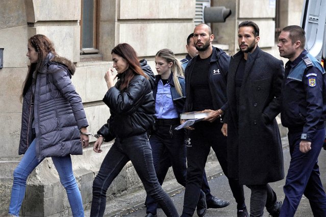 British-US former professional kickboxer and controversial influencer Andrew Tate (3rd R) and his brother Tristan Tate (2nd R) arrive handcuffed and escorted by police at a courthouse in Bucharest on January 10, 2023 for a court hearing on their appeal against pre-trial detention for alleged human trafficking, rape and forming a criminal group. (Photo by Octav Ganea/Reuters)