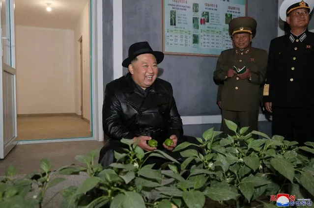 This picture taken on October 10, 2022 and released from North Korea's official Korean Central News Agency (KCNA) on October 11, 2022 shows North Korea's leader Kim Jong Un (L) visiting the Yeonpo Greenhouse Farm in South Hamgyong Province. (Photo by KCNA via KNS/AFP Photo)