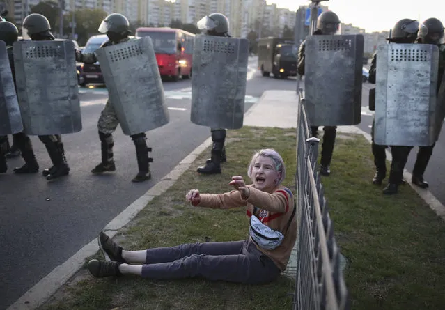 A woman reacts in front of police line during a rally in Minsk, Belarus, Wednesday, September 23, 2020. (Photo by TUT.by via AP Photo)