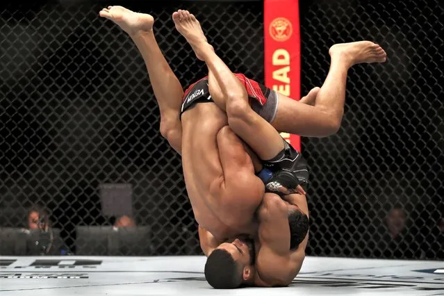 Brazil's Gabriel Bonfim, right, takes down Tunisia's Mounir Lazzez during a welterweight bout at the UFC 283 mixed martial arts event in Rio de Janeiro on Saturday, January 21, 2023. (Photo by Bruna Prado/AP Photo)