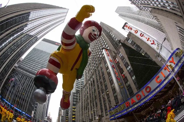 The Ronald McDonald balloon floats on sixth avenue during the 88th Annual Macy's Thanksgiving Day Parade in New York November 27, 2014. (Photo by Andrew Kelly/Reuters)