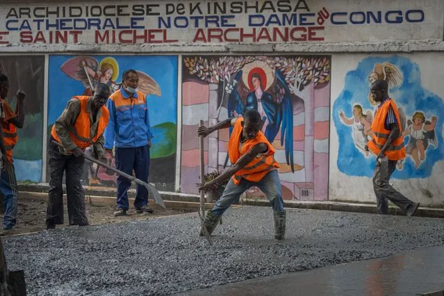 Construction workers lay concrete outside the Cathedral Notre Dame du Congo in Kinshasa, Democratic Republic of the Congo Saturday January 28, 2023. Pope Francis will be in Congo and South Sudan for a six-day trip starting Jan, 31, hoping to bring comfort and encouragement to two countries that have been riven by poverty, conflicts and what he calls a “colonialist mentality” that has exploited Africa for centuries. (Photo by Jerome Delay/AP Photo)