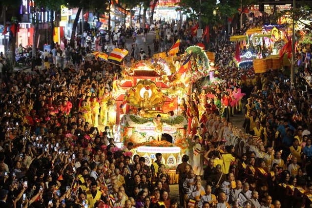 People gather to watch a procession carrying Buddha relics as part of the Vesak celebrations in Hanoi, Vietnam, 13 May 2025. The Holy Relics, which were brought from India to Vietnam for the first time, are displayed for Buddhist devotees to worship in public expositions in Ho Chi Minh, Tay Ninh, Hanoi, and Ha Nam from 2 to 21 May. (Photo by Luong Thai Linh/EPA)