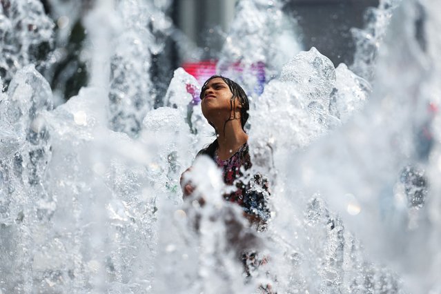 Children play in a water fountain on July 25, 2025 in Seoul, South Korea. The Korean Peninsula has been covered by a double layer of high pressure, pushing up the maximum daily temperatures to 37°C in Seoul, Daejeon and other parts of the country Friday, the state weather service said. (Photo by Chung Sung-Jun/Getty Images)