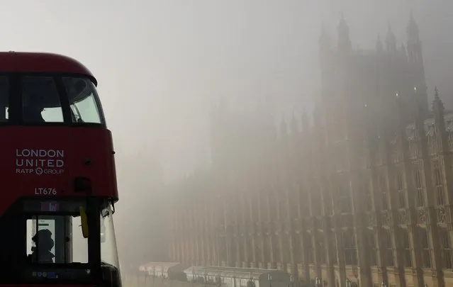 A bus is driven across Westminster Bridge past the Houses of Parliament during foggy weather in London, Britain on February 7, 2023. (Photo by Toby Melville/Reuters)
