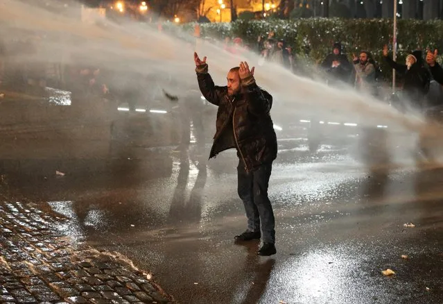 Police use a water cannon to disperse protesters during a rally against the “foreign agents” law in Tbilisi, Georgia on March 7, 2023. (Photo by Irakli Gedenidze/Reuters)