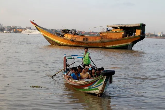 People ride on a boat as they cross the Yangon river October 23, 2015. (Photo by Soe Zeya Tun/Reuters)