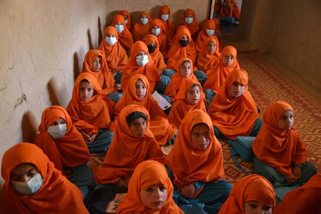 Girls attend a class at a local school in Zabul on March 14, 2023. (Photo by Sanaullah Seiam/AFP Photo)