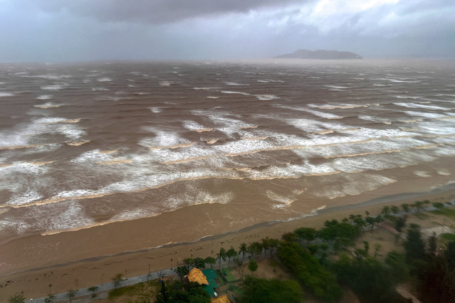 Waves approach Cua Lo beach, as seen through a window, while Typhoon Kajiki approaches in Nghe An province, Vietnam, on August 25, 2025. (Photo by Minh Nguyen/Reuters)