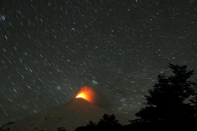 The Villarrica Volcano is seen at night in this long exposure picture from Pucon town, Chile, October 9, 2015. Villarrica is among the most active volcanoes in South America. (Photo by Cristobal Saavedra/Reuters)