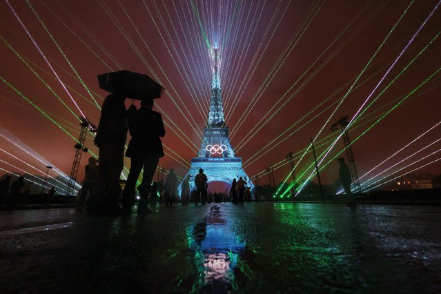 A Light Show takes place as The Olympic Rings on the Eiffel Tower are illuminated during the opening ceremony of the Olympic Games Paris 2024 at Place du Trocadero on July 26, 2024 in Paris, France. (Photo by Ryan Pierse/Getty Images)